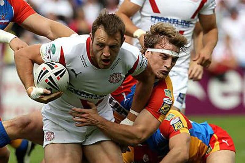 St Helens' James Roby is tackled in the victory over Harlequins yesterday.