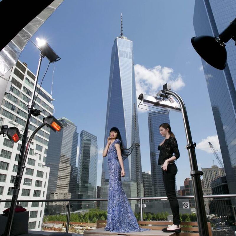 CORRECTS SPELLING OF MODEL’S NAME TO JESSICA MINH ANH INSTEAD OF JESSICA MING AHN — Fashion model Jessica Minh Anh, centre, poses during a photo shoot, with One World Trade Center as a backdrop, Monday, May 19, 2014, in New York. Anh is hosting a fashion show inside New York’s new skyscraper, June 25. (AP Photo/Mark Lennihan)