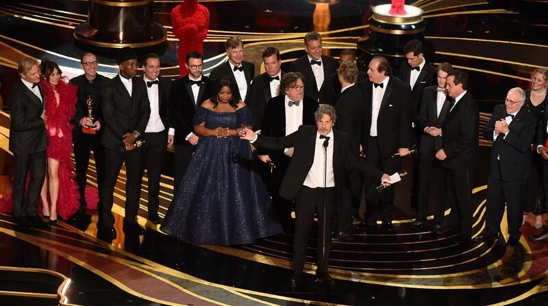 The cast and crew of Best Picture winner 'Green Book' gather on stage to accept their Oscars. AFP