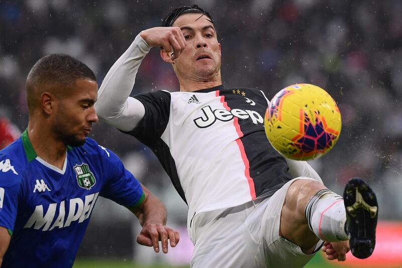 Sassuolo's German defender Jeremy Toljan (L) fights for the ball with Juventus' Portuguese forward Cristiano Ronaldo. AFP