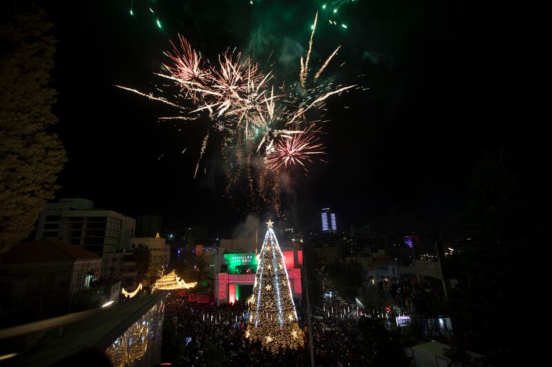 Fireworks burst over the the West Bank city of Ramallah as Palestinians gather for the lighting of the Christmas tree. AP Photo