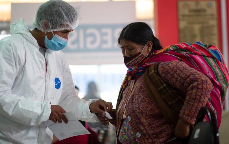 A health worker and a woman in discussion after the latter received a dose of the  Sputnik V vaccine at the Universidad Publica de El Alto, during a vaccination drive for people over 60 in El Alto, Bolivia. AP Photo