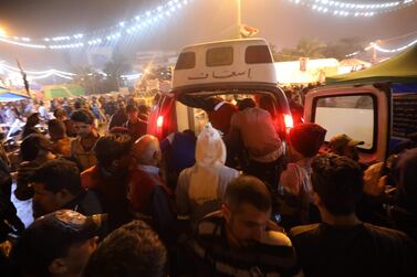 An ambulance arrives in Tahrir square after unidentified men attacked an anti-government protest camp in Baghdad late on December 6, 2019. Nine demonstrators were killed late after unidentified men attacked an anti-government protest camp in Baghdad, as the US denounced Tehran's "meddling" in Iraq and slapped sanctions on Iranian-backed fighters. Protesters had feared the rallies thronging Baghdad's main protest camp of Tahrir Square could spiral into chaos, after supporters of the Hashed al-Shaabi paramilitary group flooded the area on Thursday in a show of force. / AFP / Mahmood Alsawaf