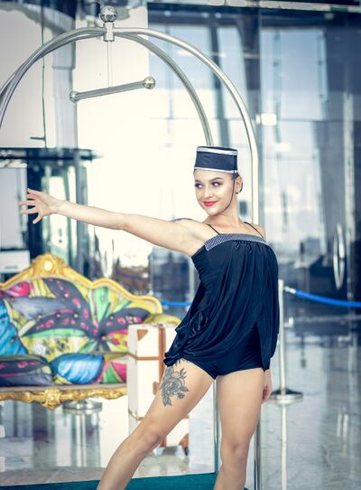 The 'concierge' performs an acrobatic show on the luggage trolley.  Photo: Conrad Abu Dhabi