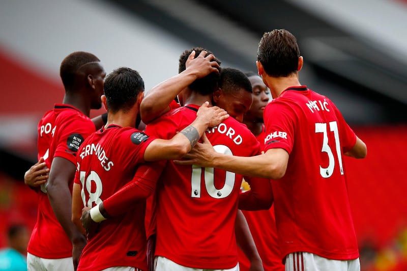 Manchester United's Marcus Rashford is congratulated by teammates after scoring a penalty. AP