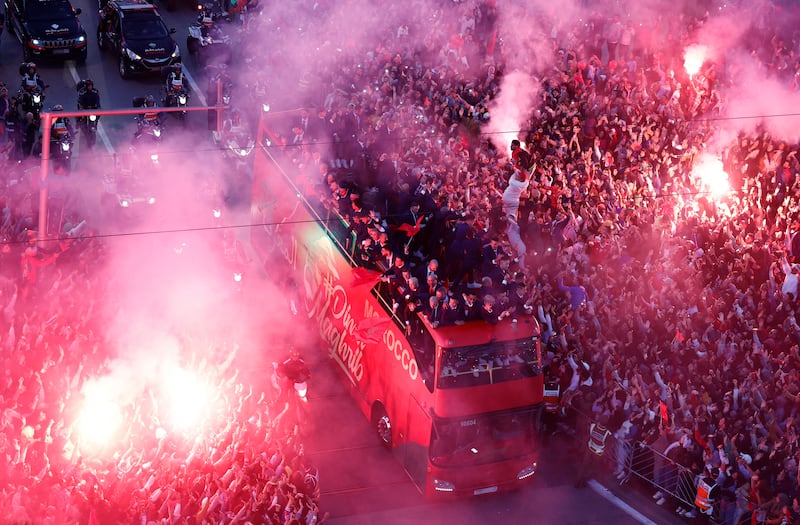 Cheering fans in Rabat celebrate with flares as Morocco's players pass through the city on an open-top bus on Tuesday, December 20, 2022. Reuters