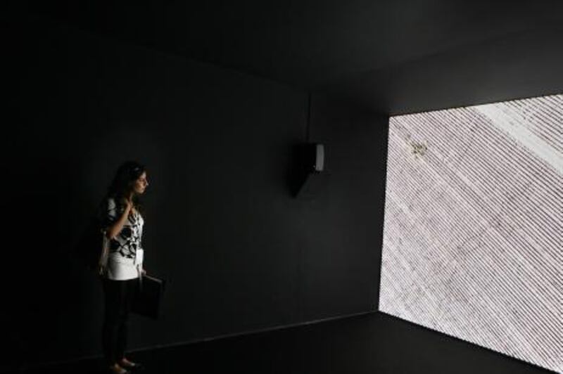 United Arab Emirates - Dubai - March 15, 2011.

ARTS & LIFE: Art India correspondent Zehra Jumabhoy (cq-al) checks out "Shadow Sites II" by Iraqi artist Jananne Al-Ani, one of the winners of the Abraaj Capital Art Prize, during its unveiling at Art Dubai at the Madinat Jumeirah in Dubai on Tuesday, March 15, 2011. Amy Leang/The National