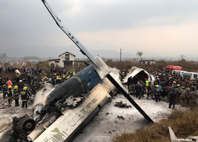 Wreckage of an airplane is pictured as rescue workers operate at Kathmandu airport, Nepal. Navesh Chitrakar / Reuters