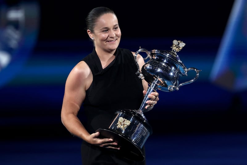 Retired former world number one Ashleigh Barty carries the Daphne Akhurst Memorial Cup ahead of the women’s singles final between Elena Rybakina and Aryna Sabalenka. AFP