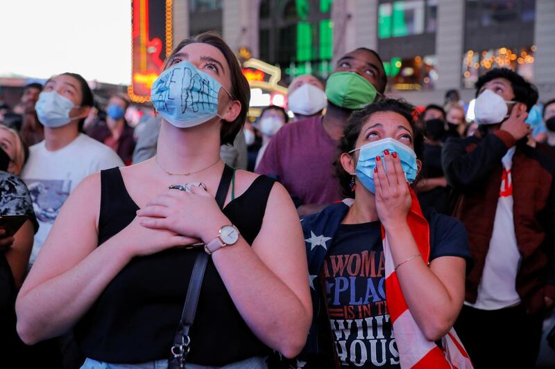 People watch a speech by Democratic vice presidential nominee Kamala Harris, at Times Square in New York City. Reuters