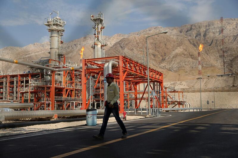 FILE - In this Nov. 19, 2015 file photo, a worker makes his way in a natural gas refinery in the South Pars gas field in Asalouyeh, Iran, on the northern coast of Persian Gulf. From brand-new airplanes to oilfields, billions of dollars of deals stand on the line for international corporations as President Donald Trump weighs whether to pull America out of Iran's nuclear deal with world powers. (AP Photo/Ebrahim Noroozi, File)