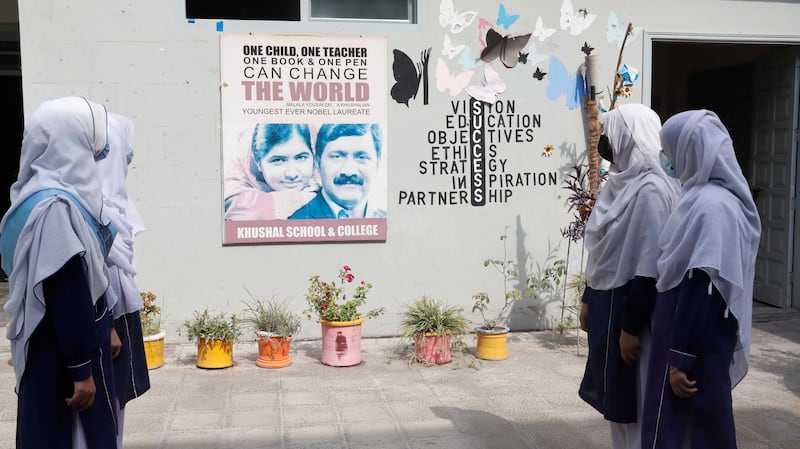 Tenth-grade pupils look at Malala's picture.