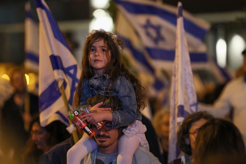A little protester on her dad's shoulders. AFP
