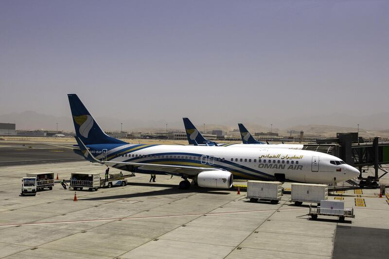 A Boeing Co. 737-800 aircraft, operated by Oman Air, stands beside the passenger terminal at Muscat International Airport in Muscat, Oman, on Monday, May 7, 2018. Being the Switzerland of the Gulf served the country well over the decades, helping the sultanate survive, thrive and make it a key conduit for trade and diplomacy in the turbulent Middle East.��Photographer: Christopher Pike/Bloomberg
