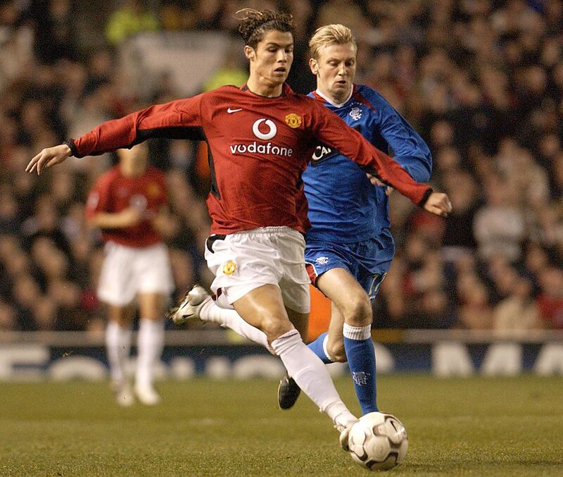 Manchester United's Cristiano Ronaldo gets a shot past Rangers Steven Hughs in tonight's UEFA Champions League clash at Old Trafford, Manchester, United Kingdom 04 November 2003. AFP Photo by Paul Barker (Photo by PAUL BARKER / AFP)