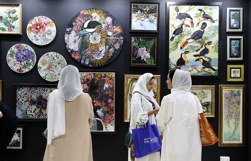 Visitors admire artworks at the Index 2024 exhibition in Dubai World Trade Centre. All photos: Pawan Singh / The National
