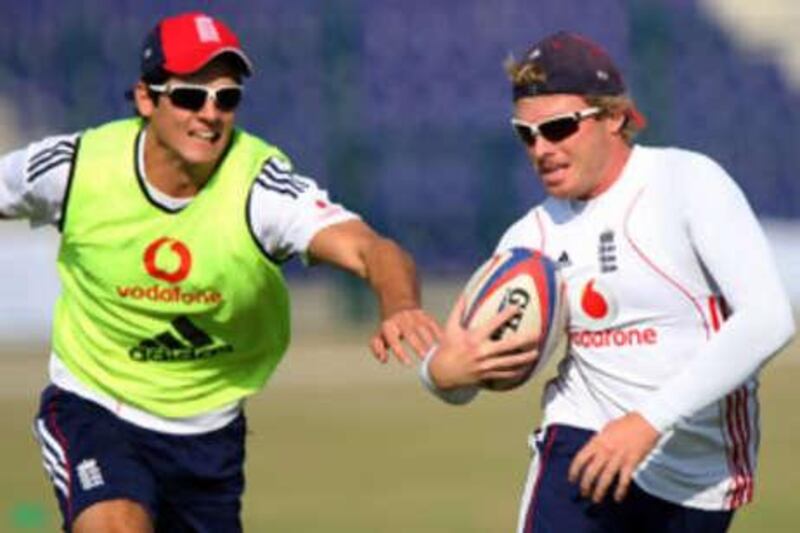 Alastair Cook, left, and Ian Bell play rugby at the Abu Dhabi Cricket Club on Dec 5 2008.