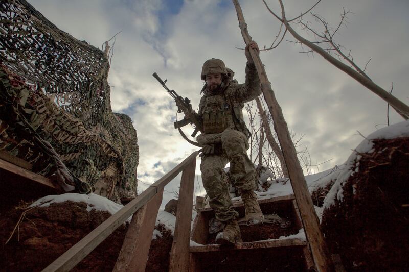 A Ukrainian soldier walks near the line of separation from Russian-backed rebels in the Donetsk region. Reuters