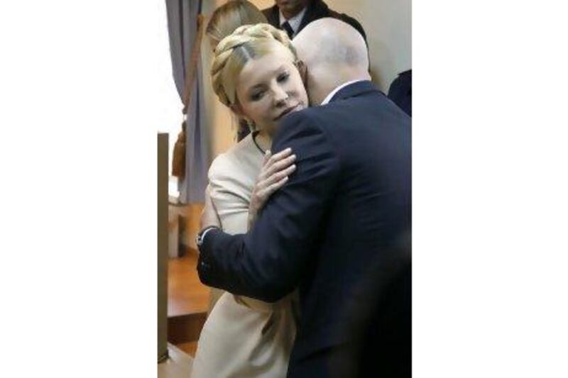 Former Ukrainian prime minister Yulia Tymoshenko is embraced by her husband Aleksandr as she is sentenced to seven years in prison for abuse of power. SERGEY DOLZHENKO / EPA