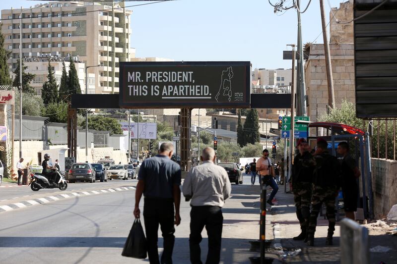 A billboard, part of a campaign organised by the Centre for Human Rights B'Tselem, installed before US President Joe Biden's arrival for an official visit in the West Bank city of Bethlehem. PA