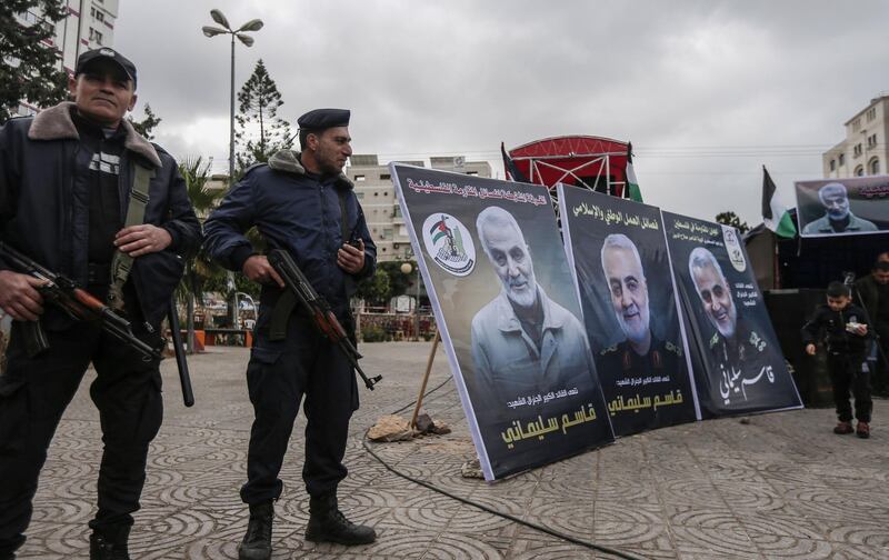 Hamas policemen in Gaza City stand guard during a mourning ceremony organised in honour of slain Iranian military commander Qasem Soleimani (portrait) killed in the Iraqi capital Baghdad in a US air strike a day earlier, on January 4, 2020.  / AFP / MAHMUD HAMS
