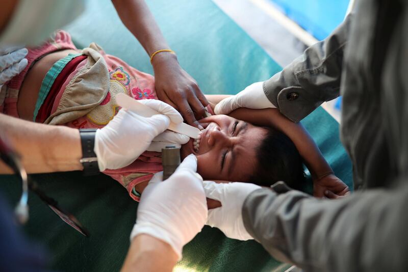 A doctor checks a Rohingya child at Samaritan's Purse diphtheria clinic in Cox's Bazar, Bangladesh. Mohammad Ponir Hossain / Reuters