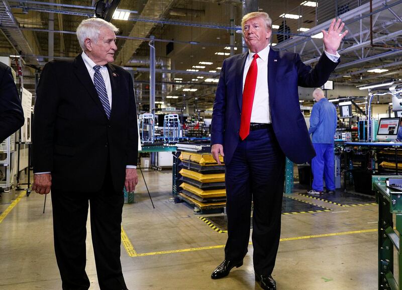 US President Donald Trump speaks next to US Rep John Carter during a tour of Apple's Mac Pro manufacturing plant. Reuters