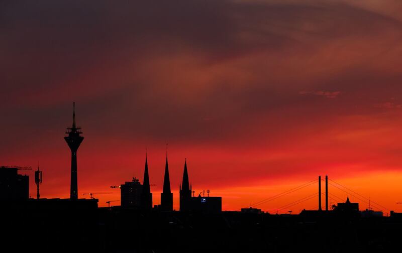 The sun sets  over the TV tower "Rheinturm" in Duesseldorf, Germany. Kevin Kurek/AFP
