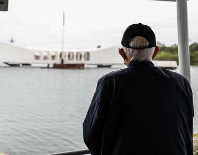 In this handout image courtesy of the US Navy, a veteran from the Second World War observes the USS Arizona Memorial during a harbour tour as part of the 80th Anniversary Pearl Harbour Remembrance on December 5, 2021. "AFP Photo / US Navy / Petty Officer 1st class Sean La Marr