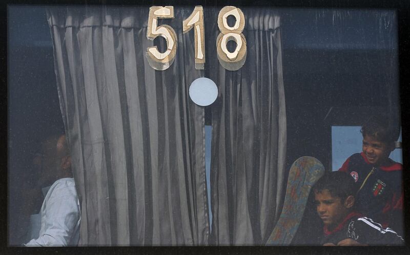 Iraqis sit in a bus transporting displaced families from a camp in Habbaniyah in Iraq's Anbar province. AFP