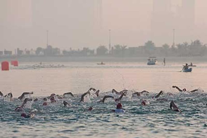 Competitors swim along the beaches of Corniche in the early morning start of the triathlon. The swimming festival starts tomorrow morning.