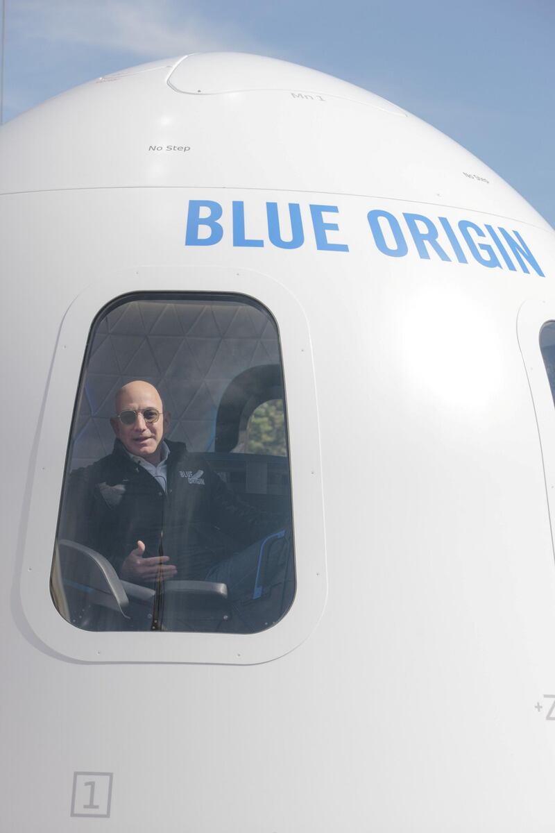 Jeff Bezos, chief executive officer of Amazon.com Inc. and founder of Blue Origin LLC, sits inside the high fidelity crew capsule mock up of the Blue Origin New Shepard system during the Space Symposium in Colorado Springs, Colorado, U.S., on Wednesday, April 5, 2017. Bezos has been reinvesting money he made at Amazon since he started his space exploration company more than a decade ago, and has plans to launch paying tourists into space within two years. Photographer: Matthew Staver/Bloomberg