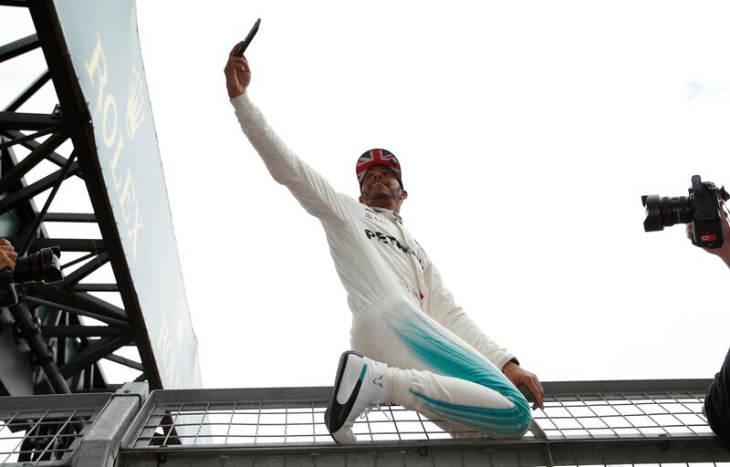 F1 - Formula One - British Grand Prix 2017 - Silverstone, Britain - July 16, 2017   Mercedes' Lewis Hamilton celebrates his win by taking a selfie   REUTERS/Andrew Boyers