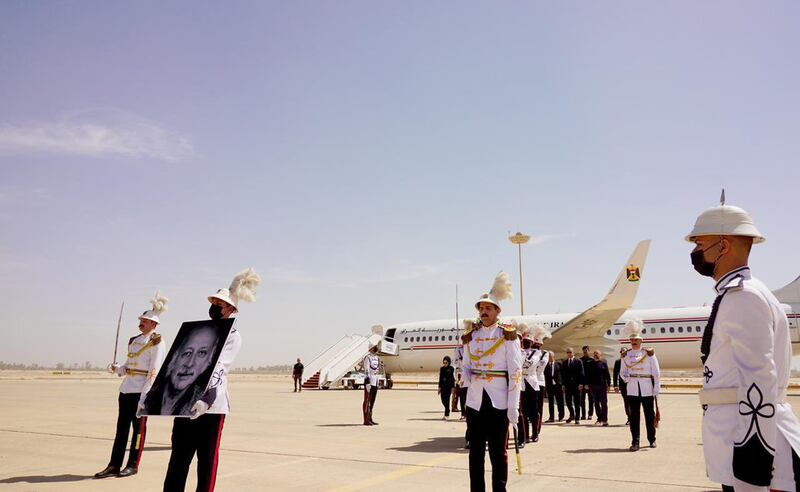 An Iraqi soldier holds a portrait of Al Nawab during a ceremony at Baghdad airport. Iraq PMO Twitter