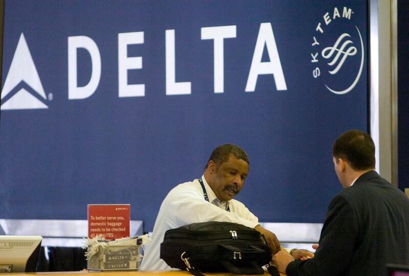 epa08124932 (FILE) - A Delta Air Lines ticket agent (L) assists a passenger at Hartsfield Jackson Atlanta International Airport in Atlanta, Georgia, USA on 15 April 2008 (reissued 13 January 2020). Delta Airlines is to release their 4th quarter 2019 results on 13 January 2020.  EPA/ERIK S. LESSER