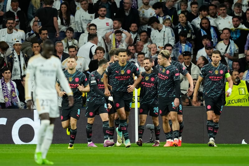 Bernardo Silva, third right, celebrates with his teammates after scoring Manchester City's opening goal in the Champions League quarter-final first leg against Real Madrid at the Santiago Bernabeu stadium in Madrid, Spain, on Tuesday, April 9, 2024. AP
