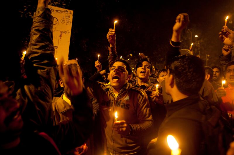 Indians shout slogans during a candle-lit vigil to mourn the death of a gang rape victim in New Delhi, India, Sunday, Dec. 30, 2012. The woman who died after being gang-raped and beaten on a bus in India's capital was cremated Sunday amid an outpouring of anger and grief by millions across the country demanding greater protection for women from sexual violence. (AP Photo/ Dar Yasin) *** Local Caption ***  India Gang Rape.JPEG-038c2.jpg