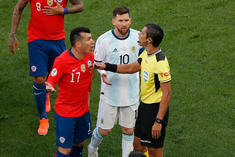 Chile's Gary Medel, left, and Argentina's Lionel Messi, centre, protest to referee Mario Diaz after both of them were sent off. AP Photo