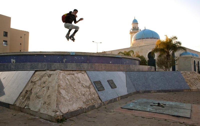 Palestinain Mahmoud Neta,20, jumps over the dry fountain by the Sheikh Zaid Mosque in the Sheikh Zayed City housing project in Gaza. Heidi Levine for The National