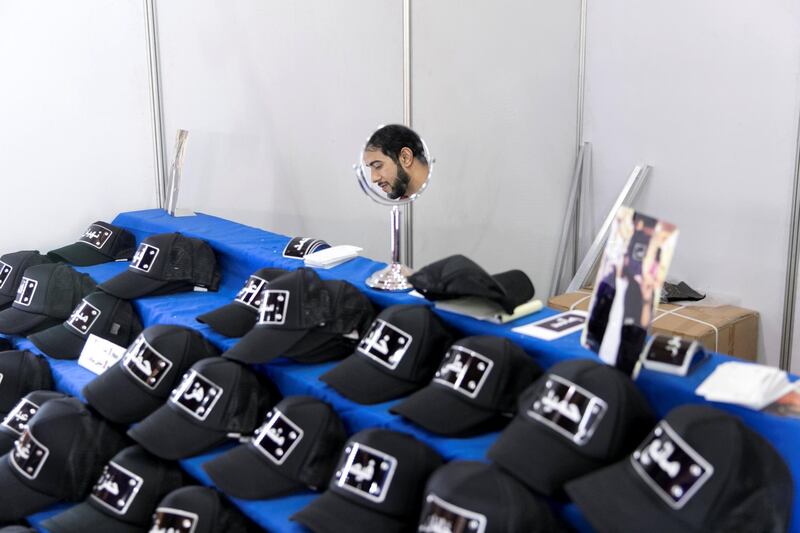 RAS AL KHAIMAH, UNITED ARAB EMIRATES - AUGUST 13, 2018. 

Abdul Fattah Abu Maaroof sells customized caps at Ras Al Khaima's Eid Al Adha fair.

(Photo by Reem Mohammed/The National)

Reporter: RUBA HAZA
Section:  NA