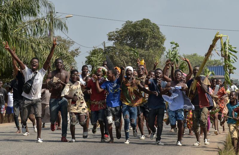 People celebrate in the streets of Divo, on January 15, 2019 after the International Criminal Court acquitted the former Ivory Coast president. Judges ordered the immediate release of 73-year-old deposed strongman Laurent Gbagbo, the first head of state to stand trial at the troubled ICC, and his former youth leader Charles Ble Goude, 47.  / AFP / Sia KAMBOU

