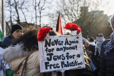 A protester with a sign reading "Never Again for Anyone! Jews For a Free Palestine" outside the International Court of Justice during the court ruling in The Hague, Netherlands, on January 26. Bloomberg