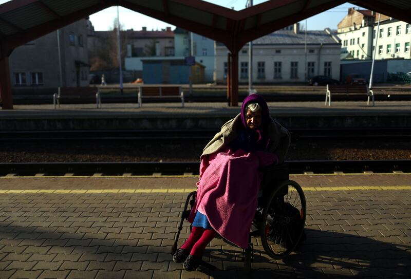 Ukrainian refugee Zoya Vertegel, aged 85, waits to board a train to Krakow on the platform at Przemysl Glowny train station.  Reuters