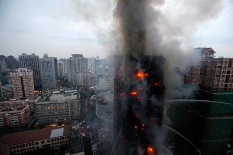 Firefighters try to extinguish the blaze at the building in Shanghai.