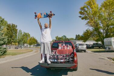 Nathan Apodaca holding his skateboard while standing in the back of a truck in Idaho Falls, Idaho, US, on October 6. Mr Apodaca is enjoying fame from a 22-second TikTok video that has racked up over 28 million views since he posted it last month. Wesley White/Ocean Spray via AP