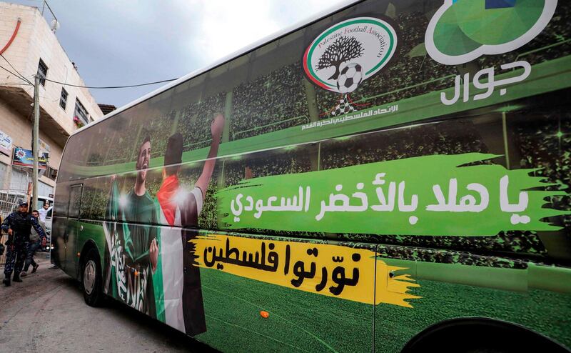 Palestinian security forces guard a Palestinian Football Association bus as the teams of Palestine and Saudi Arabia arrive ahead of their World Cup 2022 Asian qualifying match in the town of al-Ram in the Israeli-occupied West Bank. The game would mark a change in policy for Saudi Arabia, which has previously played matches against Palestine in third countries. Arab clubs and national teams have historically refused to play in the West Bank, where the Palestinian national team plays, as it required them to apply for Israeli entry permits. AFP