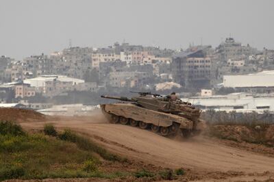 An Israeli tank moves near the border with the Gaza Strip as seen from a position on the Israeli side of the border on March 17, 2024. Getty Images. 