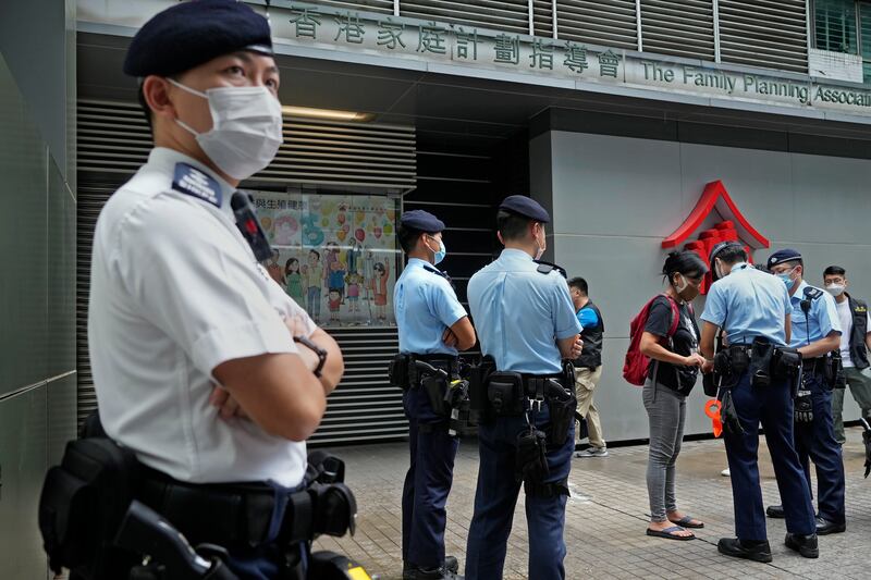 A protester is searched by police officers during a demonstration against an Election Committee voting in Hong Kong on Sunday. Photo: AP