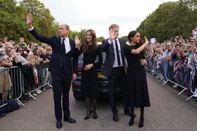 Prince William, Prince of Wales, Kate, Princess of Wales, Prince Harry and Meghan, Duchess of Sussex wave to members of the public at Windsor Castle, following the death of Queen Elizabeth II. AP 