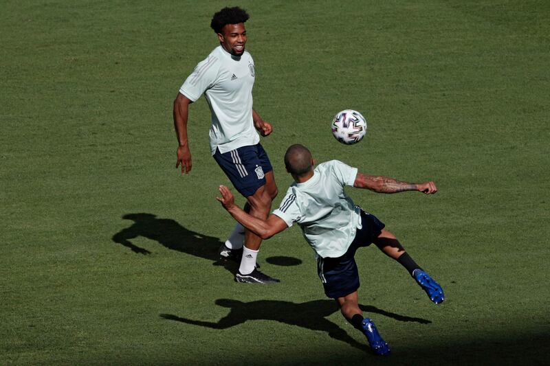 Midfielder Thiago Alcantara (R) passes the ball ahead of Spain's midfielder Adama Traore. AFP